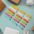 A hand sealing a snack bag with a blue airtight food clip.