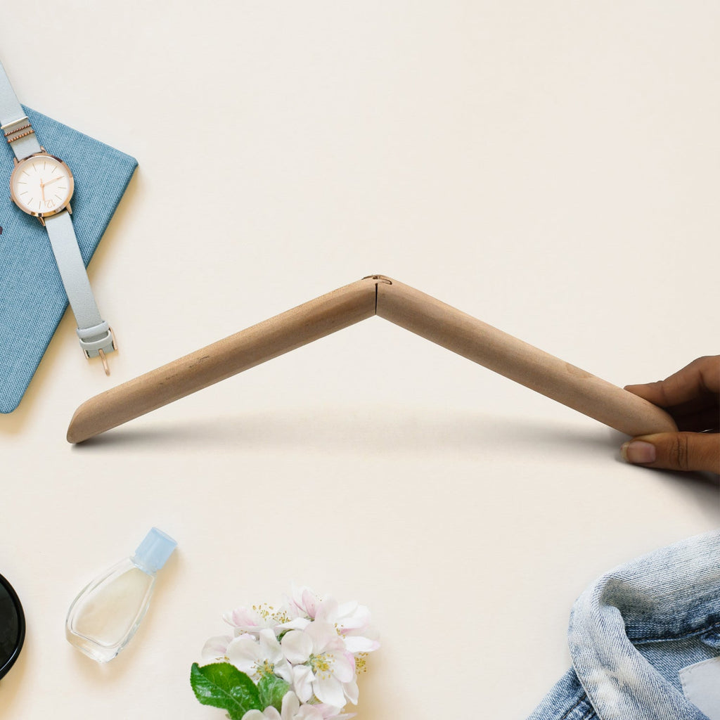 Front view of a sturdy wooden suit hanger against a light background.
