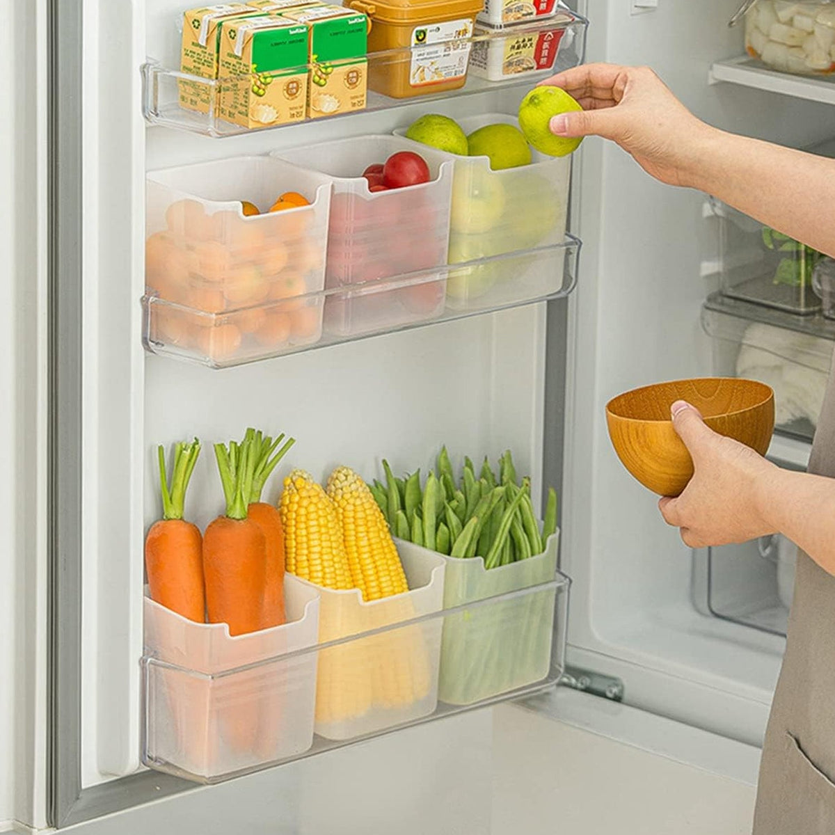 Top-down view of a clear plastic drawer organizer with several small items inside.