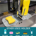Overhead view of the silicone faucet mat holding a sponge and soap dispenser, functioning as a drying pad.
