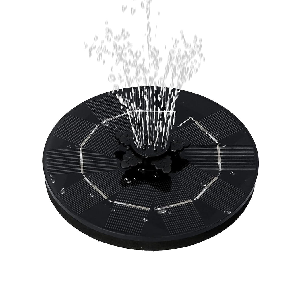 The solar floating water fountain demonstrating a wide, gentle spray pattern in a garden pool.