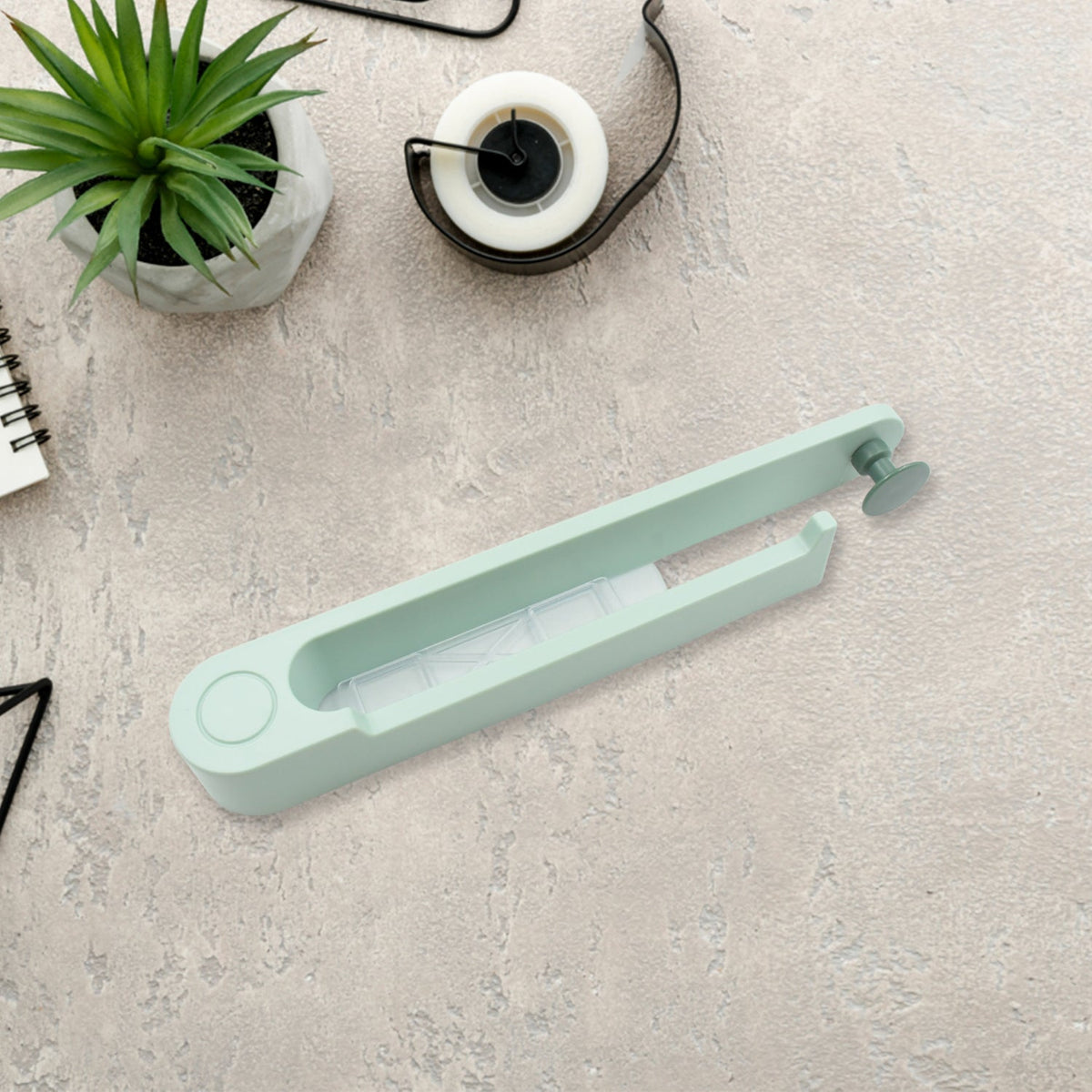 Compact plastic towel holder with a sturdy round hook for easy hanging.