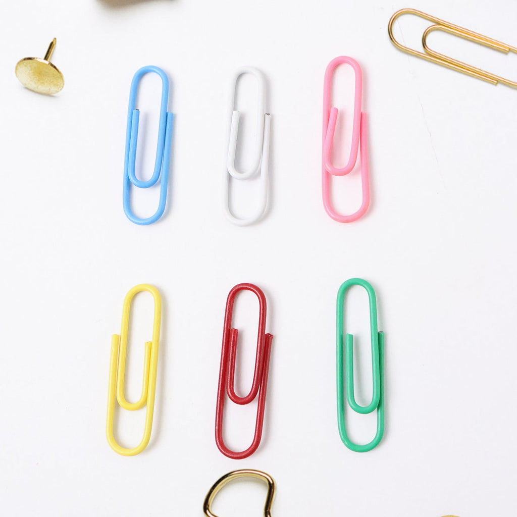 Close-up of multicolor office paper clips holding papers securely
