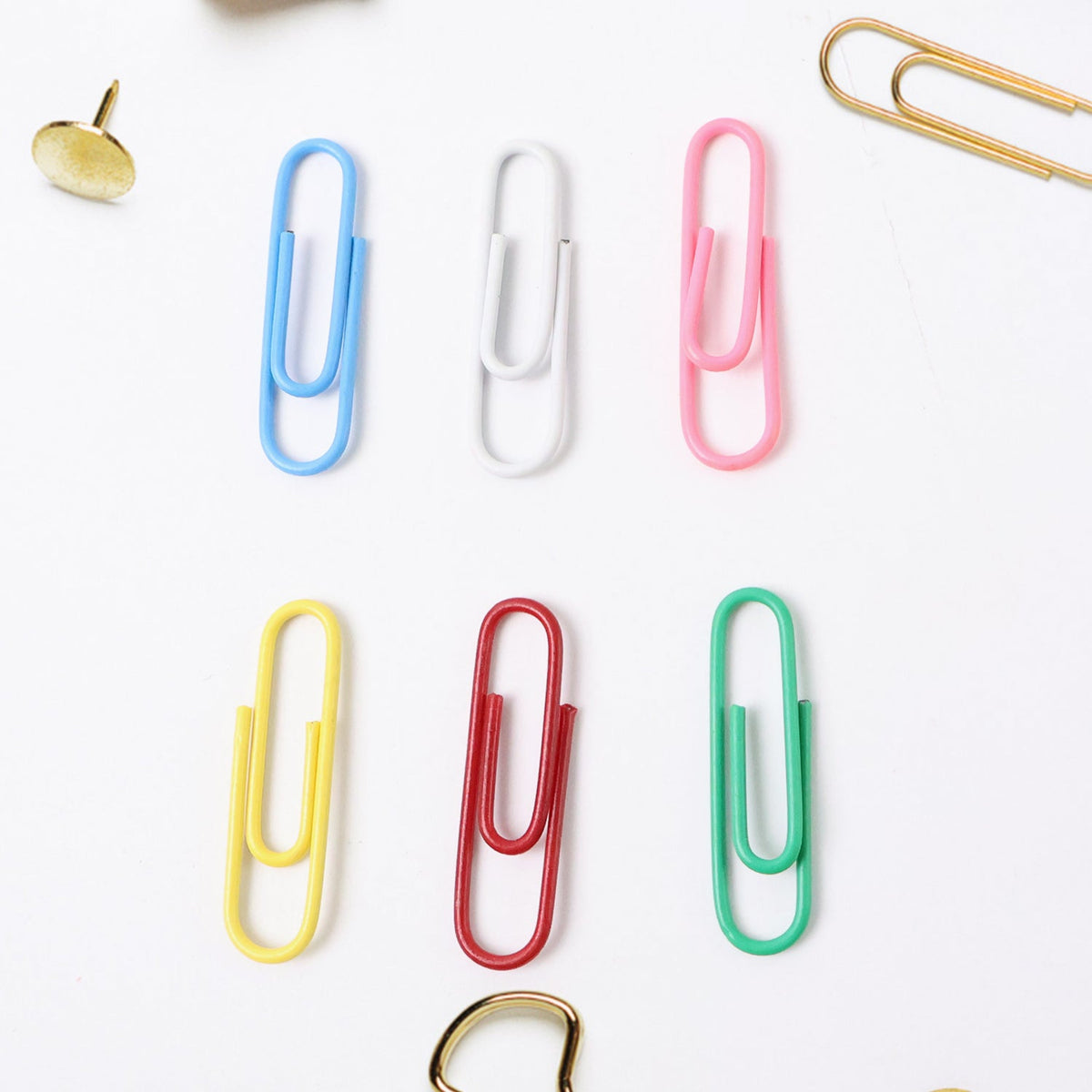 Close-up of multicolor office paper clips holding papers securely