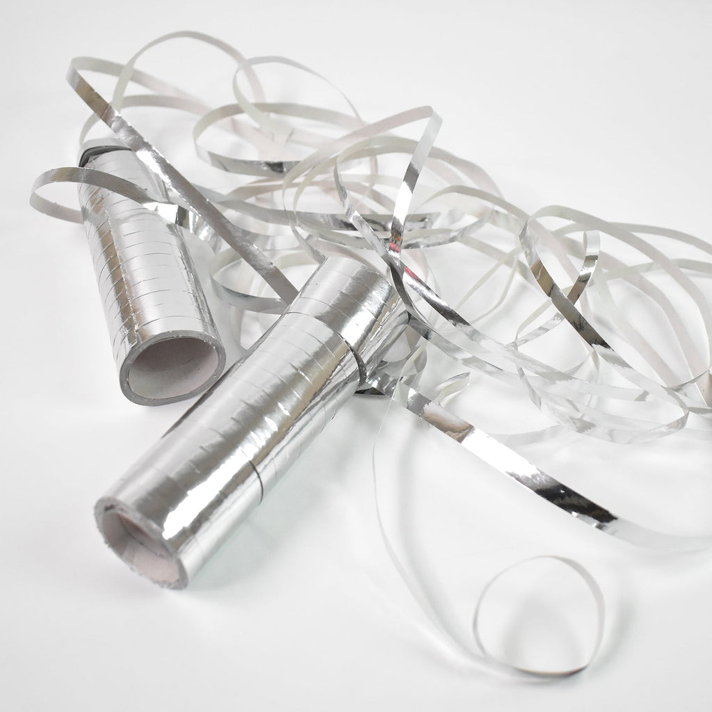 Variety of silver ribbons for crafting and decoration.