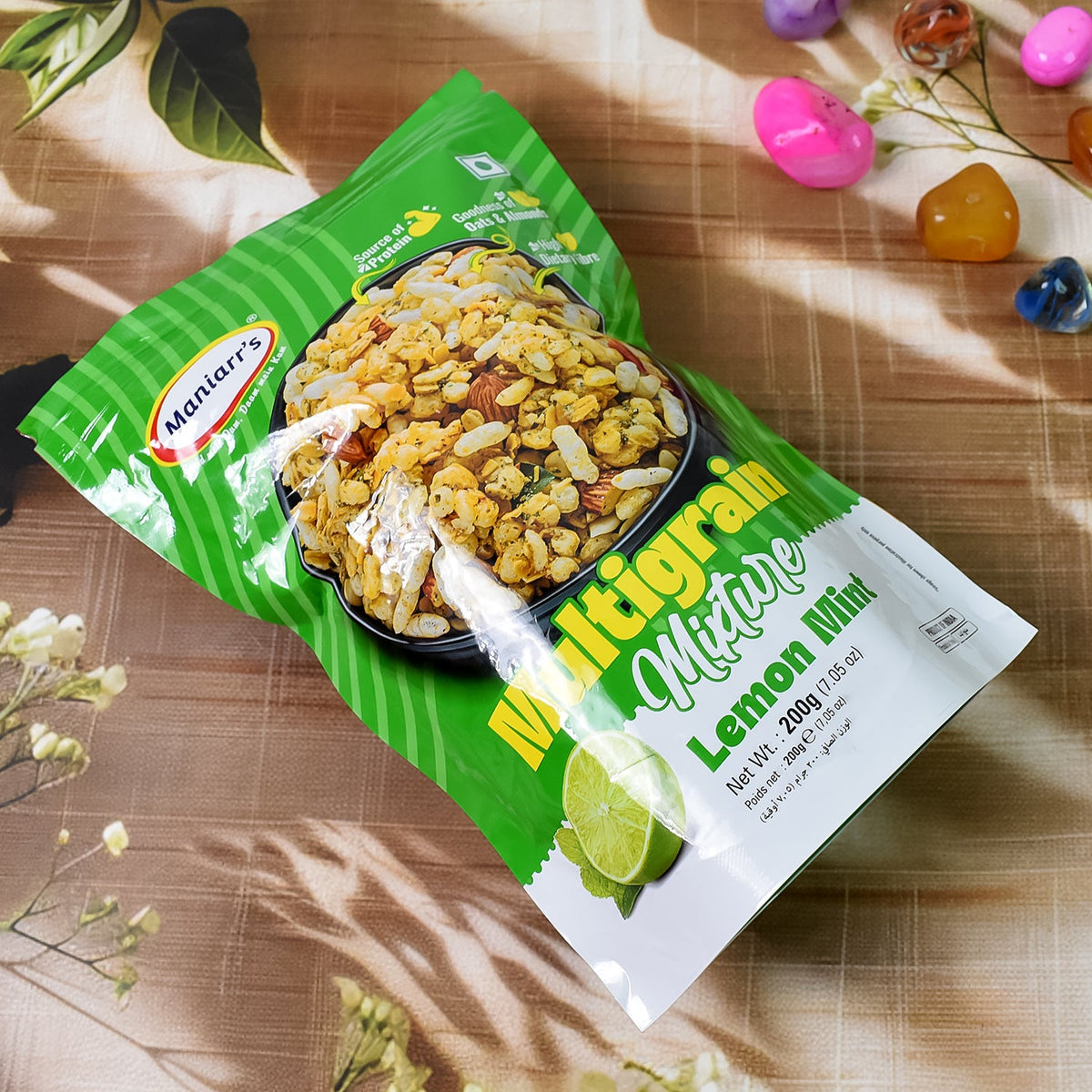 Front view of Maniarr's Roasted Multigrain Mixture packaging highlighting key benefits.