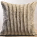 Stylish corduroy pillow cover enriching a cozy sofa with a warm throw blanket.