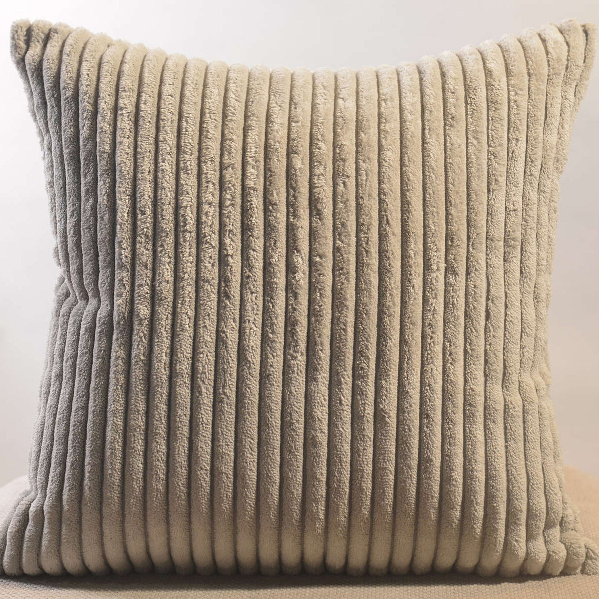 Stylish corduroy pillow cover enriching a cozy sofa with a warm throw blanket.