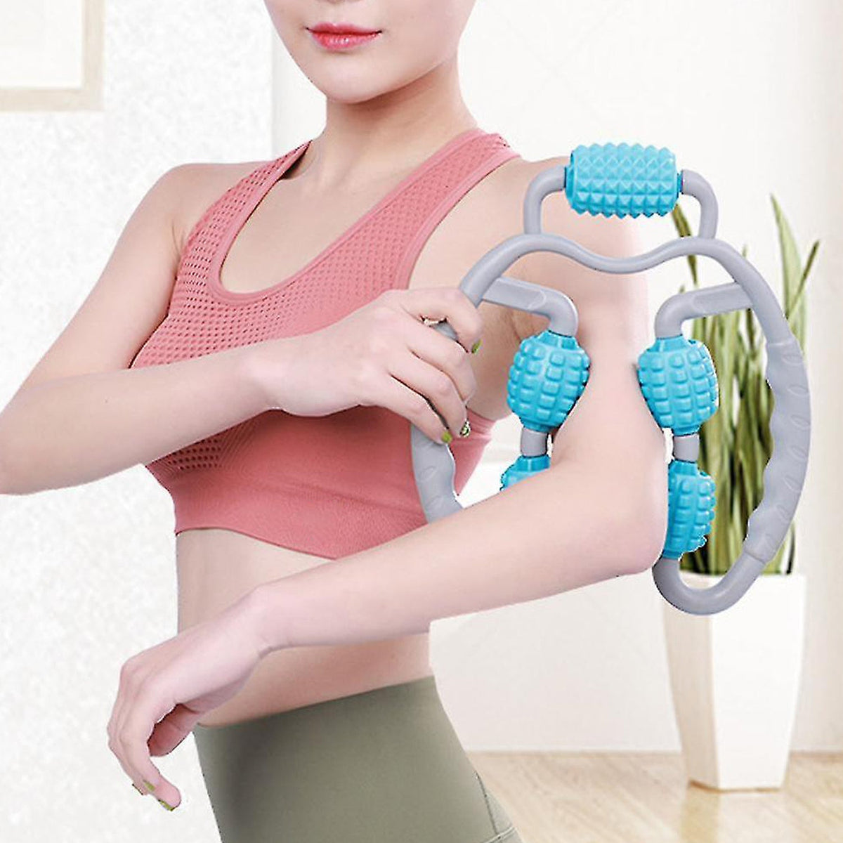 User demonstrating the 5-wheel muscle massage roller on their calf to relieve muscle soreness.