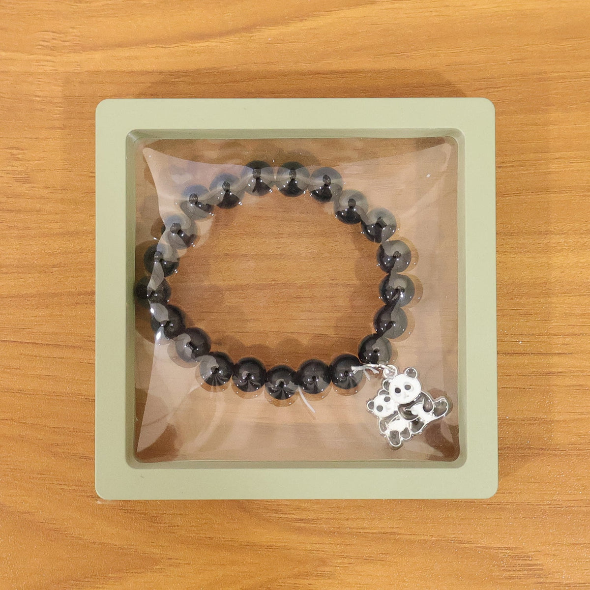 Multicolor pastel bead stretch bracelet shown with vibrant glossy beads and charm