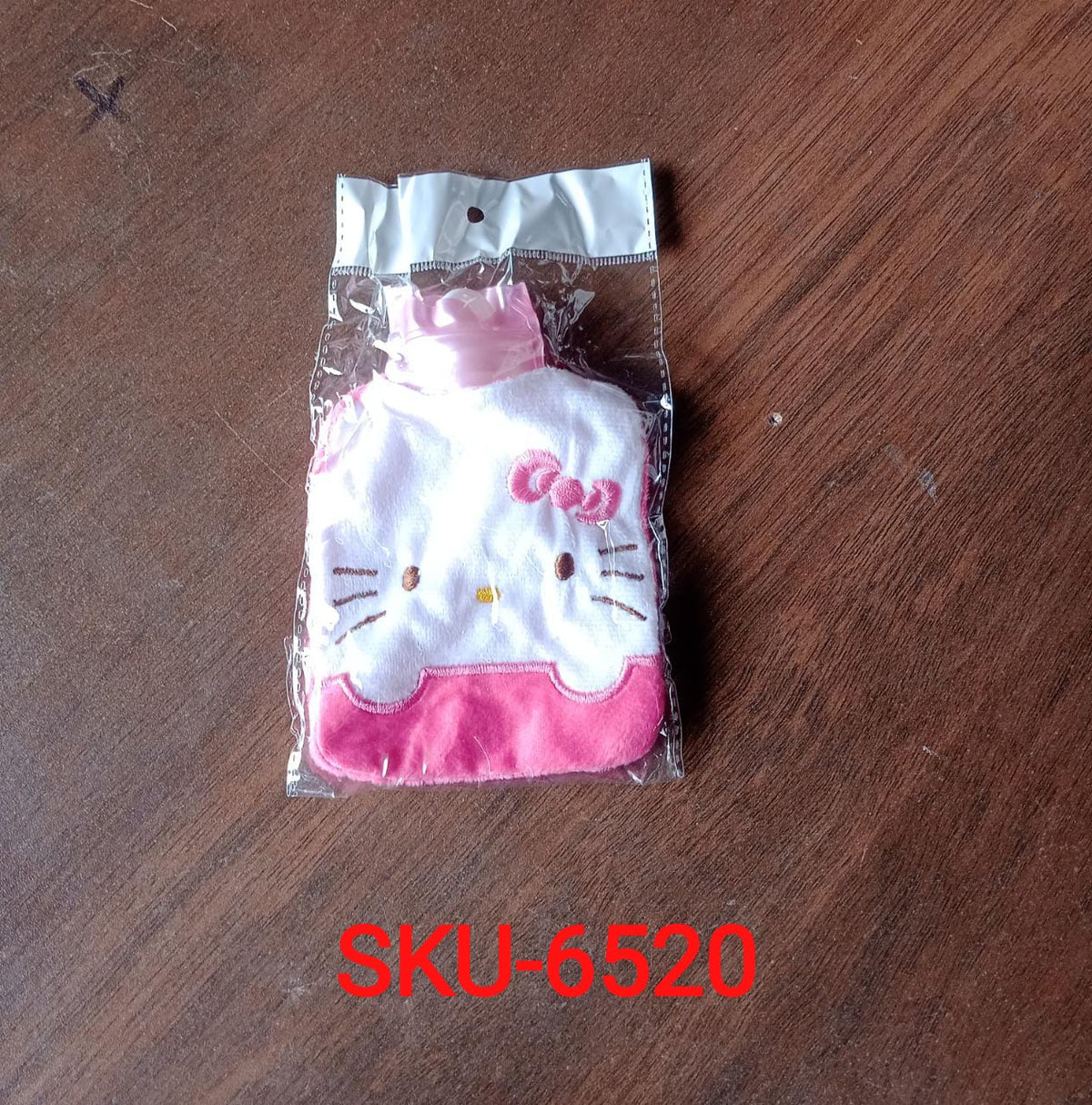 Pink hot water bag with cover, a cozy solution for warmth and pain relief.