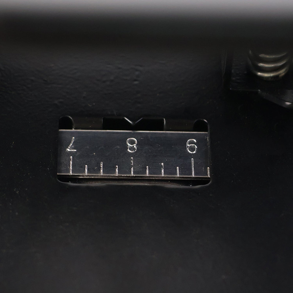 Close-up of hole punch area on metal 2-hole paper punch machine