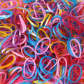 Vibrant multicolor rubber bands neatly stacked in a pile.