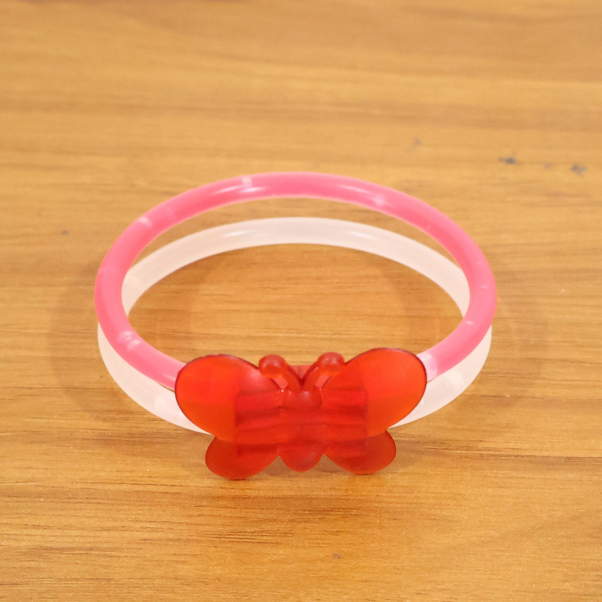 Glowing butterfly bracelet worn on wrist during night party