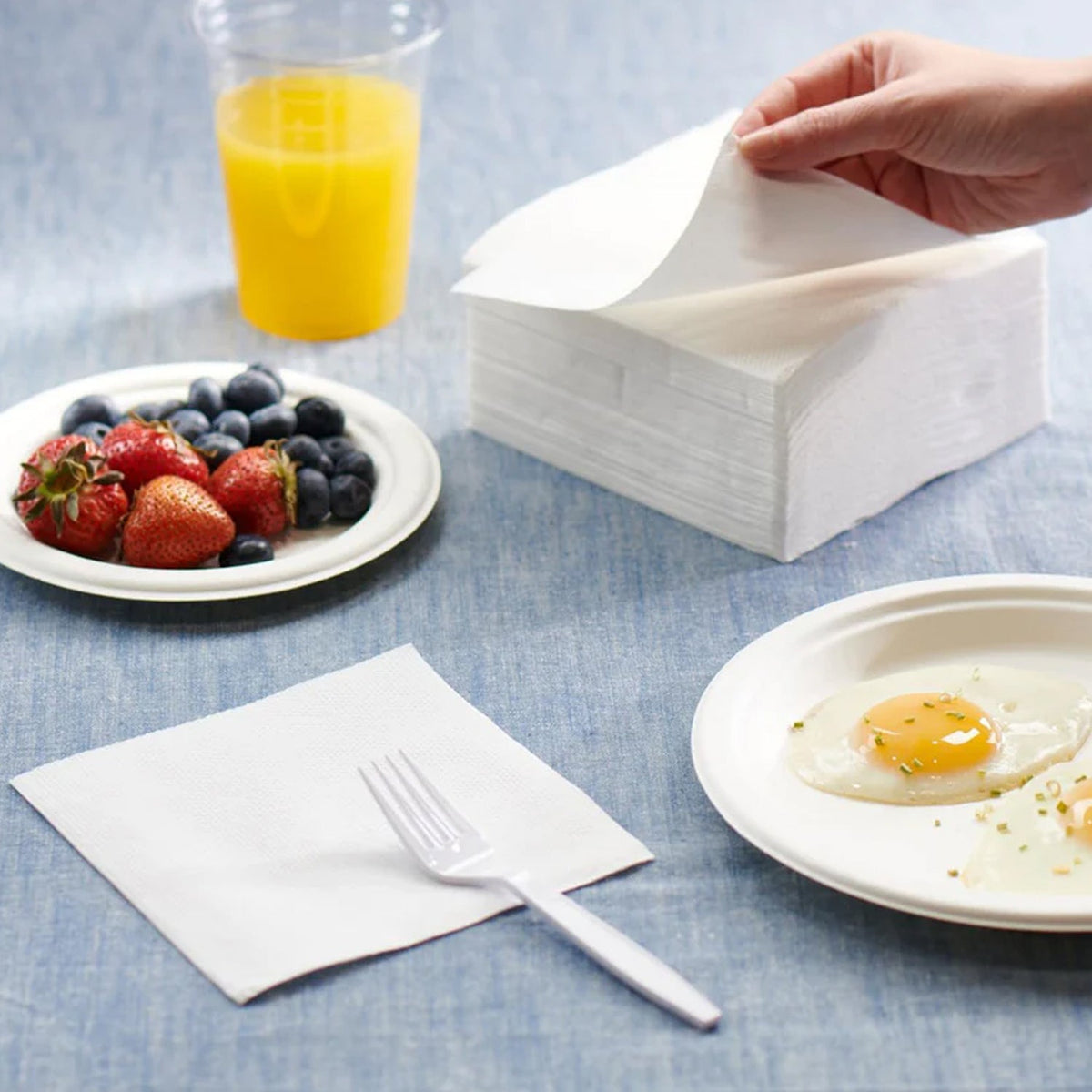 Stacked disposable tissue napkins ready for use